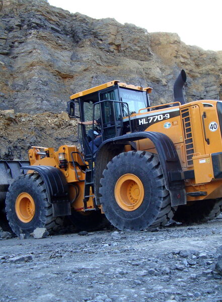 Wheel loader in a limestone quarry transporting blasted limestone