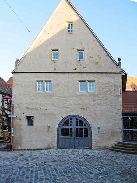 Historic building with natural lime plaster facade and arched entrance portal